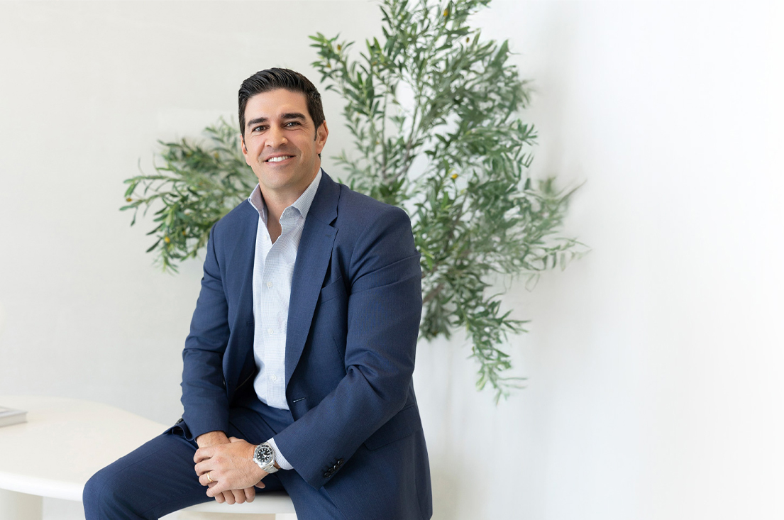 Manny Lorenzana Sitting on Desk